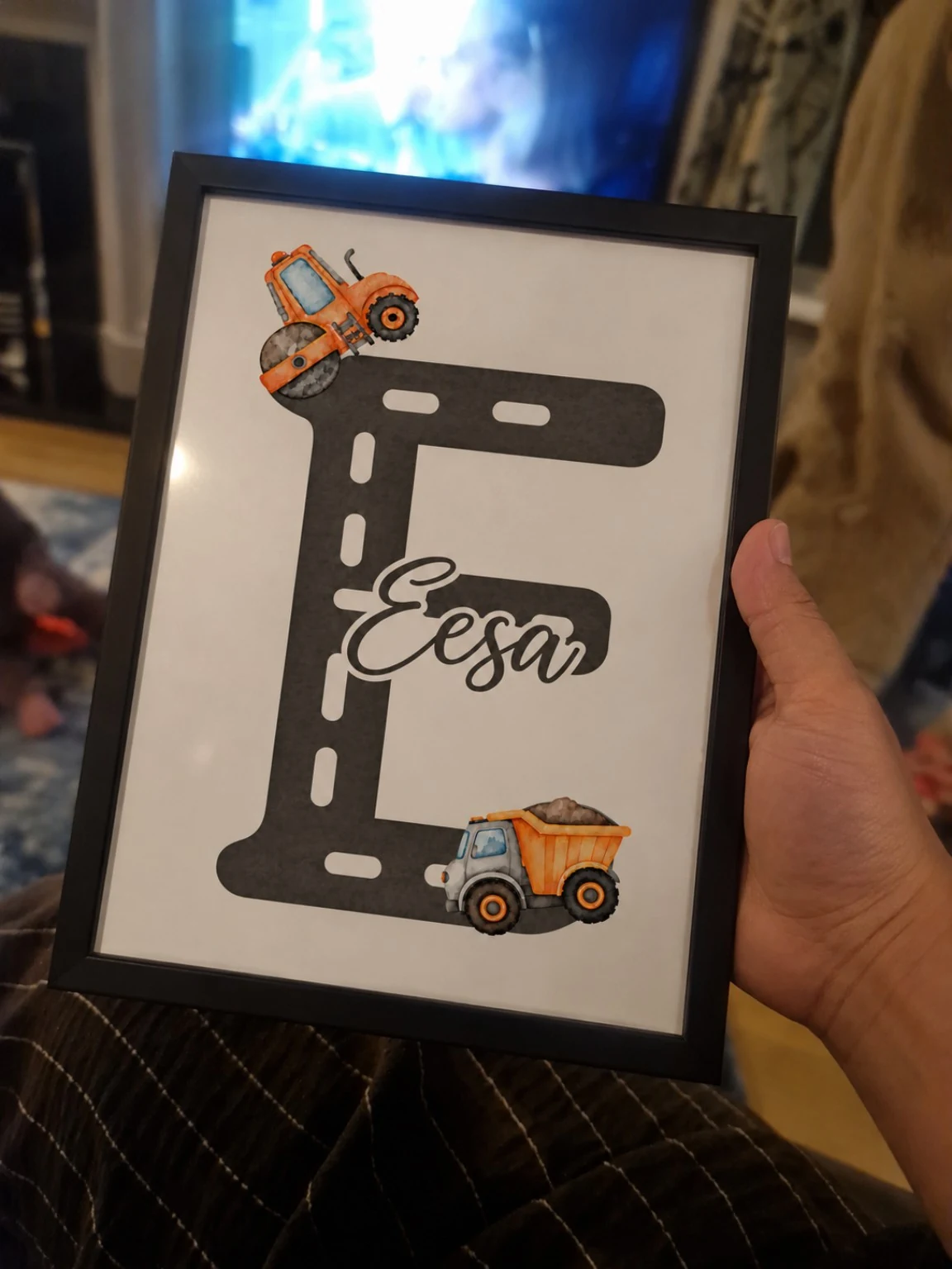 Framed Eesa train themed name print held up at home